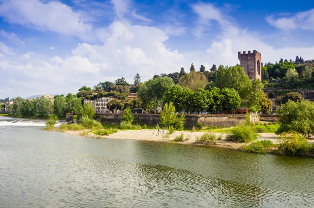 Since antiquity and throughout the 14th century, the Arno was one of Florences major resources for producing energy for the water - driven manufactories along its course. The river was also exploited for fluvial transport and as a natural supply of water for the city. The Wool Merchants Guild owned numerous facilities on the river, such as a fulling mill, used in the various cycles of processing wool and fabrics. The so - called pescaie or steccaie made of wood or vegetal material contributed to the work of channeling the river. the Pescaia di San Niccolo, situated in the vicinity of the gate of the same name, furnished water, destined in part to the needs of the population, to the mills located inside the walls.